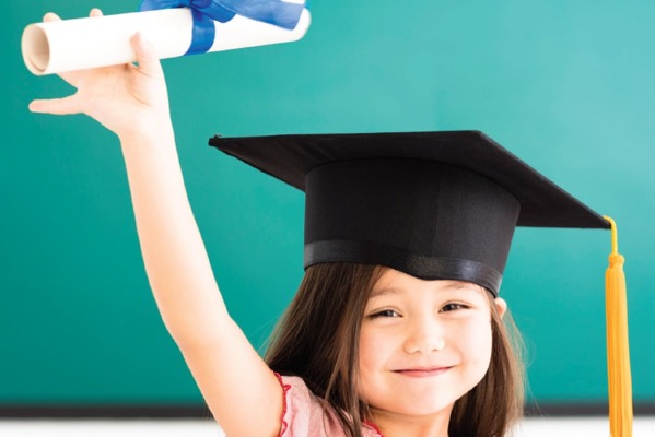 A girl holding her graduation certificate