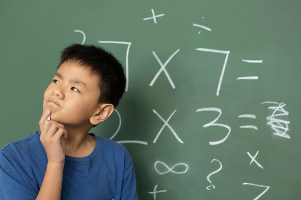 Child contemplating solutions to math problems